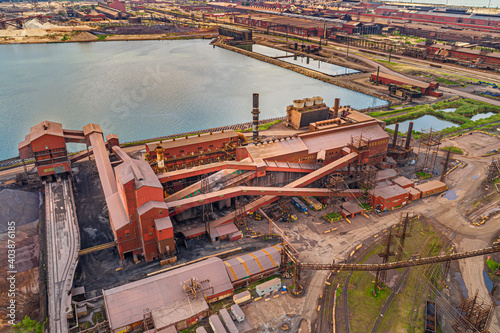 Aerial View of Vast Industrial Landscape. Steel Mills and Heavy Industry, Rail Lines, Bridges, Shipping Canal, Harbor, etc.