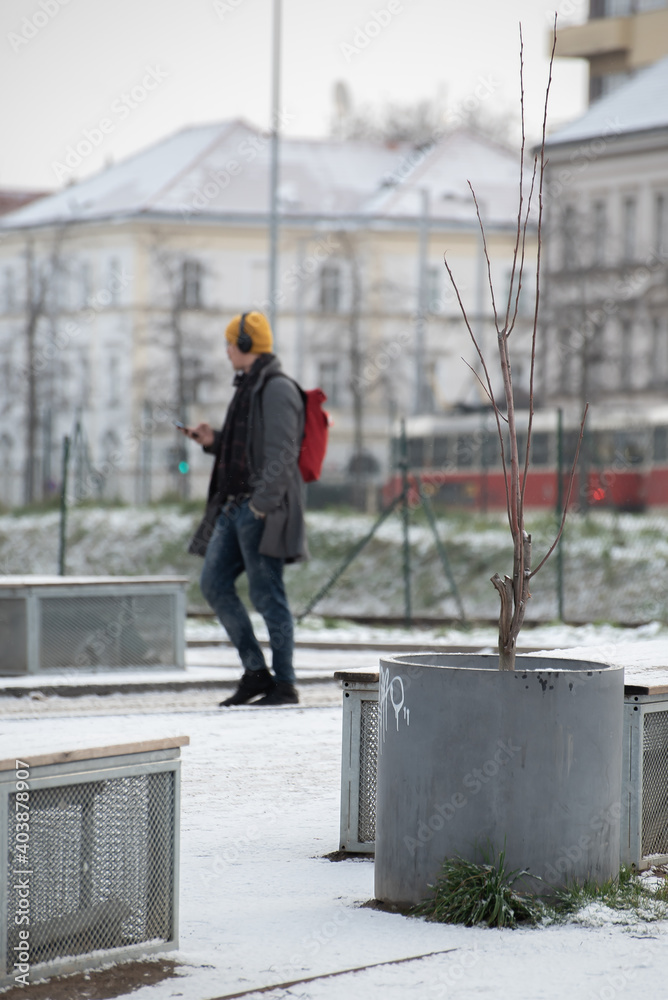 Snowing day on Prague. People walk on Park Letna while tram travel through the city, close to Hradcanska in Prague 6