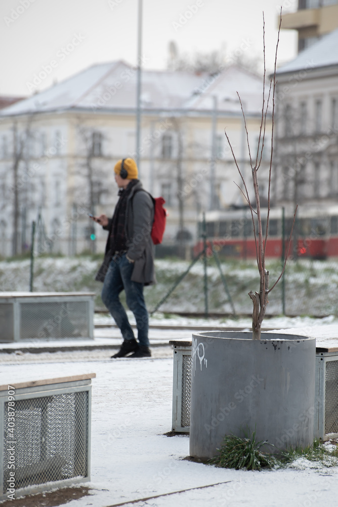 Snowing day on Prague. People walk on Park Letna while tram travel through the city, close to Hradcanska in Prague 6 Snowing day on Prague. People walk on Park Letna while tram travel through the city, close to Hradcanska in Prague 6