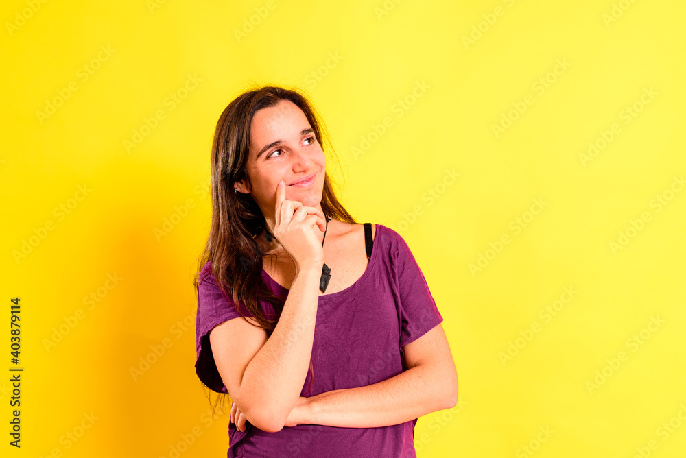 Normal young woman with relaxing meditative gesture dressed casual, isolated on studio background.