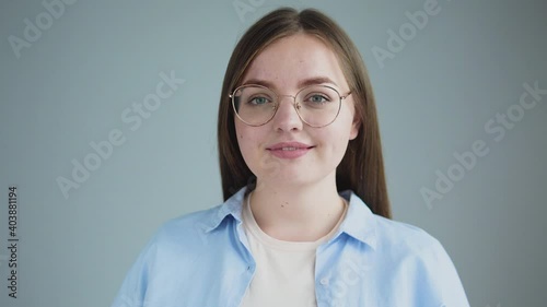 Attractive happy chubby girl in eyeglasses looking at camera and smiling success photo