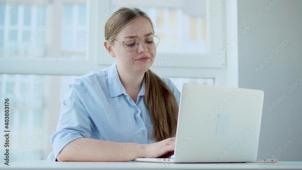 Bored dissatisfied woman office worker typing on laptop, doing work reluctantly