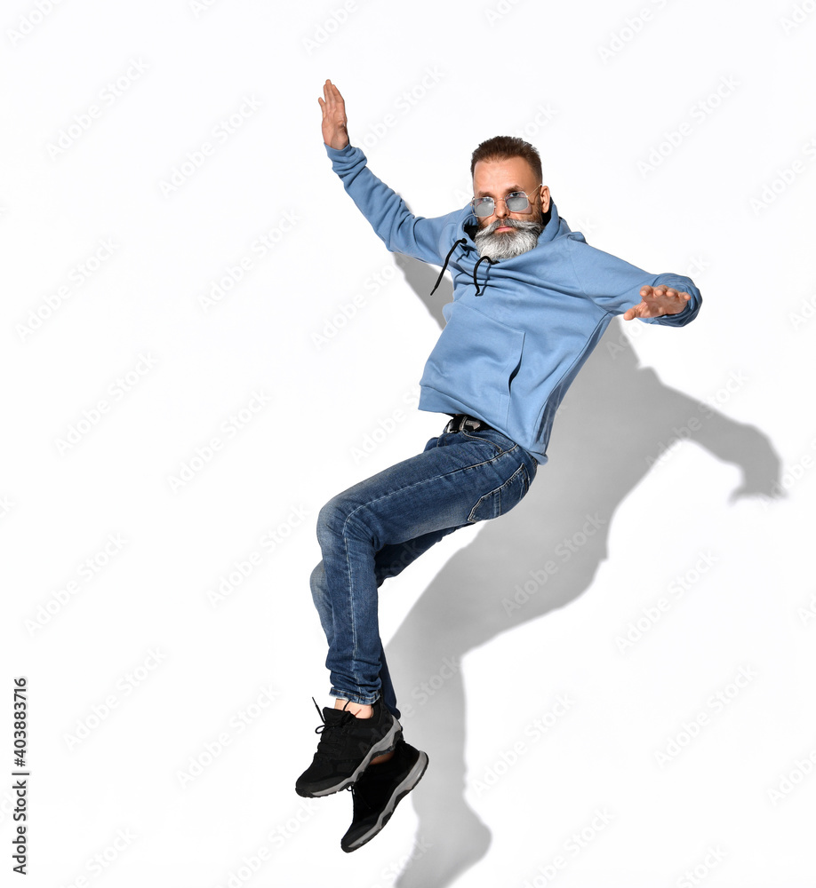 Picture a man with a beard in stylish sunglasses full-length fun, it jumps high above the ground or falls from a height Picture a man with a beard in stylish sunglasses full-length fun, it jumps high above the ground or falls from a height