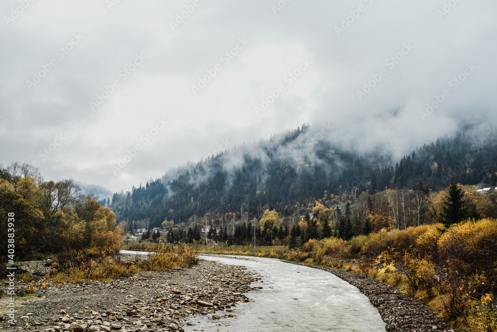 mountain river flows among mountains in fog and forest 3