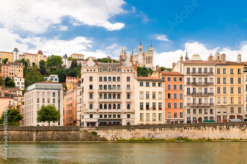 Vieux-Lyon, colorful houses in the center, on the river Saone, with the Fourviere cathedral in background © Pascale Gueret