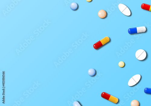 Medicines on light blue background with copy space. Realistic pills and capsules.