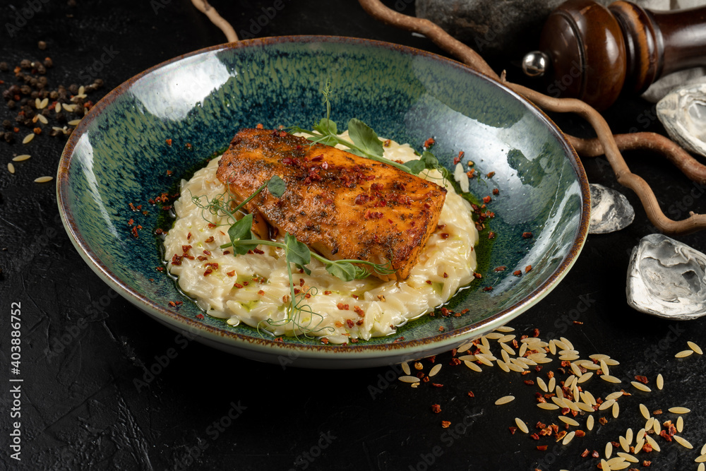 Salmon with orzo pasta. A hot main course of sea fish and pasta.