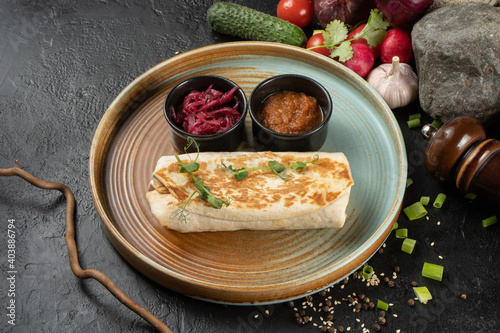 Burrito with vegetables. Shawarma. A hot appetizer of chicken and vegetables wrapped in pita bread or flatbread.