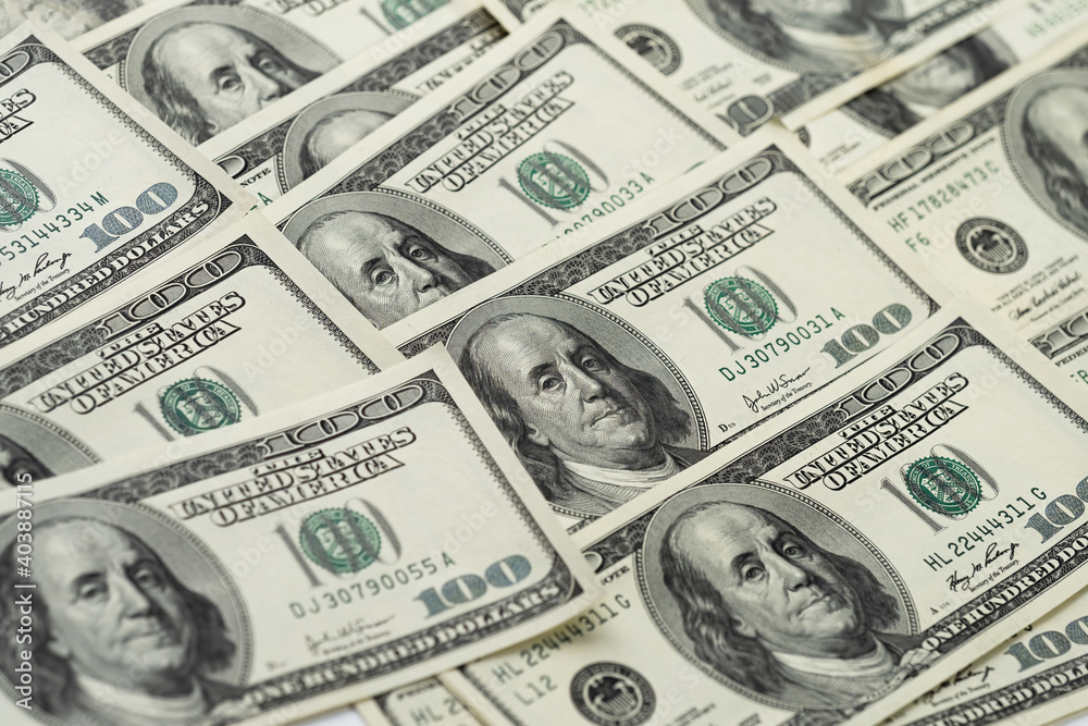 A money pile of one hundred US banknotes with president Franklin portrait. Cash of hundred dollar bills, paper currency background A money pile of one hundred US banknotes with president Franklin portrait. Cash of hundred dollar bills, paper currency background