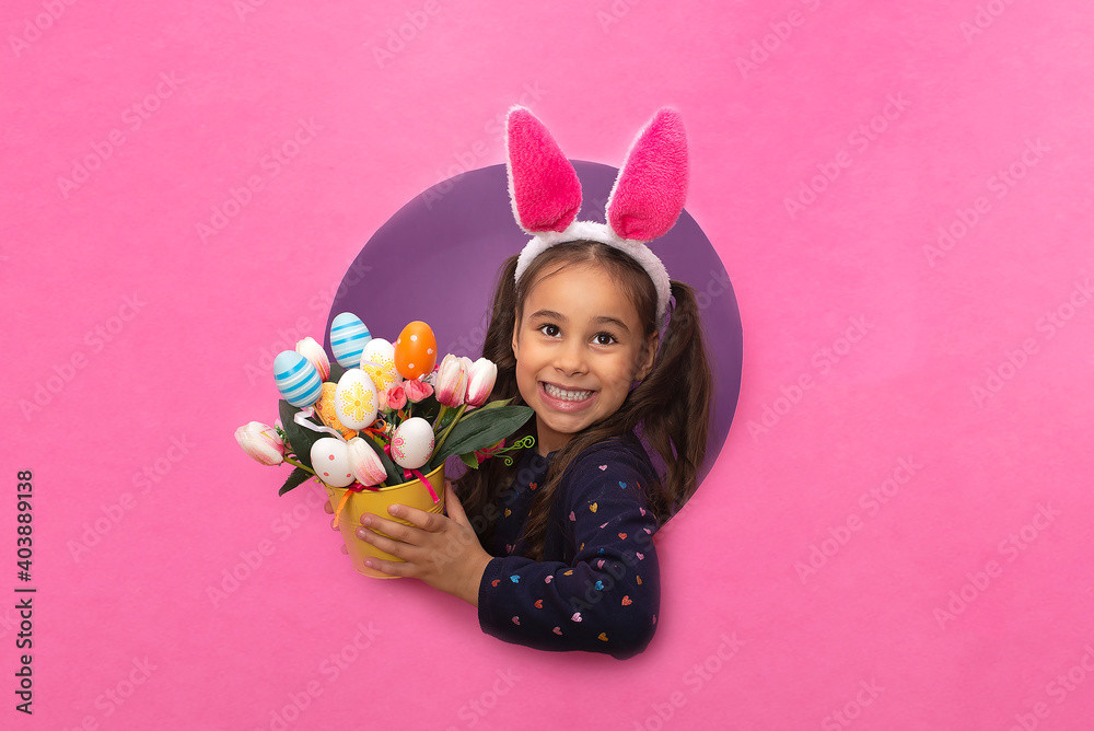 Cute happy little child girl is wearing bunny ears on Easter day