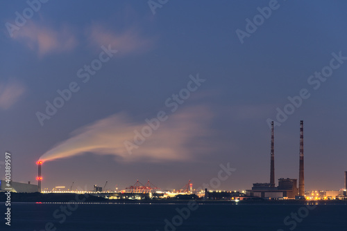 Dublin Waste to Energy (Covanta Plant), Poolbeg CCGT and Pigeon House Power Station view from Seapoint Beach during the blue hour, Dublin, Ireland photo