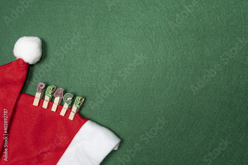 Top view Santa Claus hat with clips word peace on green background photo