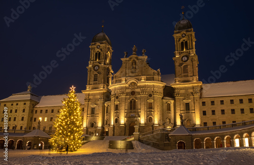 Illuminated swiss abbey of Einsiedeln at blue hour in Christmas winter time