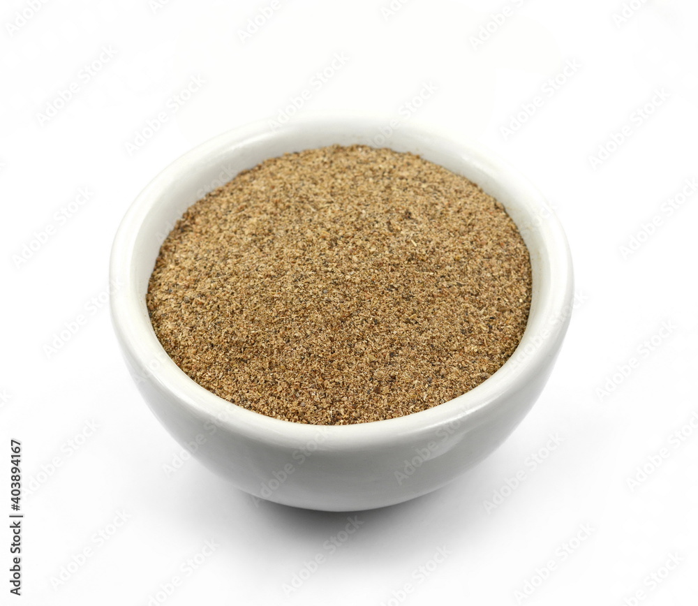 Ground carob powder (Ceratonia siliqua) in a bowl isolated on white background. Ripe carob pods and carob powder, can be used as a substitute for cocoa. Ground carob powder (Ceratonia siliqua) in a bowl isolated on white background. Ripe carob pods and carob powder, can be used as a substitute for cocoa.