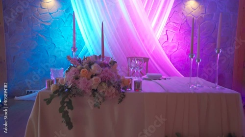 Wedding table with flower decoration and pink light