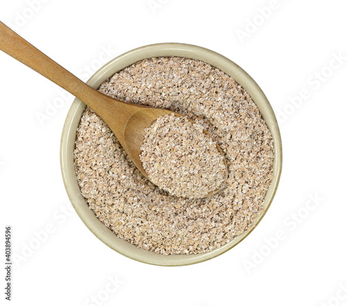 Dry spelt bran in a bowl isolated on white background. Powder Organic Spelt Bran.