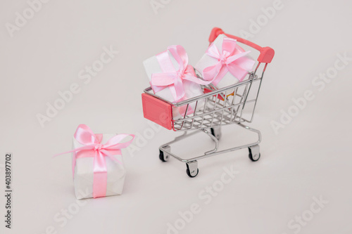 Pink gift box in basket, holiday concept