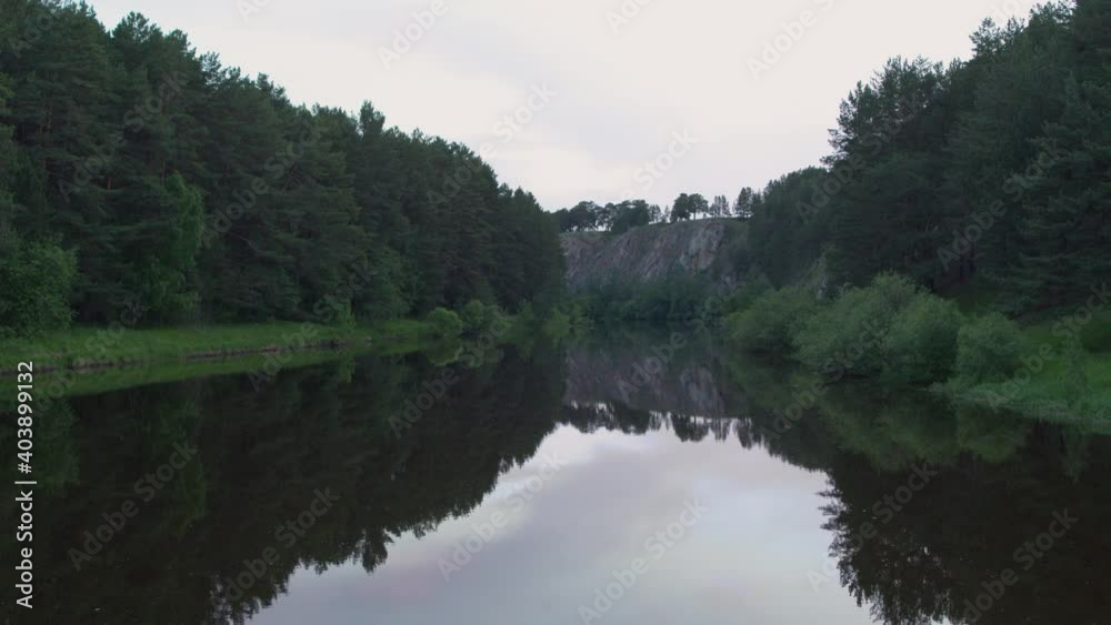 Aerial view of the river with smooth water and forest on the banks Aerial view of the river with smooth water and forest on the banks