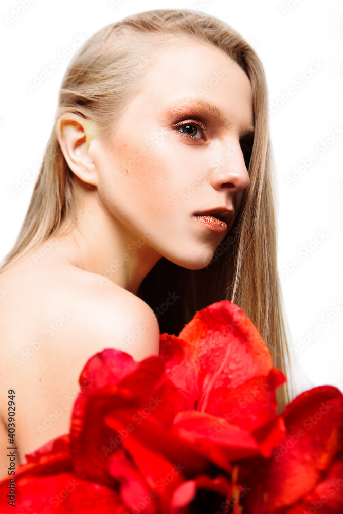 Portrait of tender a beautiful young woman with a red flower isolated on white background. Beauty and fashion. Portrait of tender a beautiful young woman with a red flower isolated on white background. Beauty and fashion.