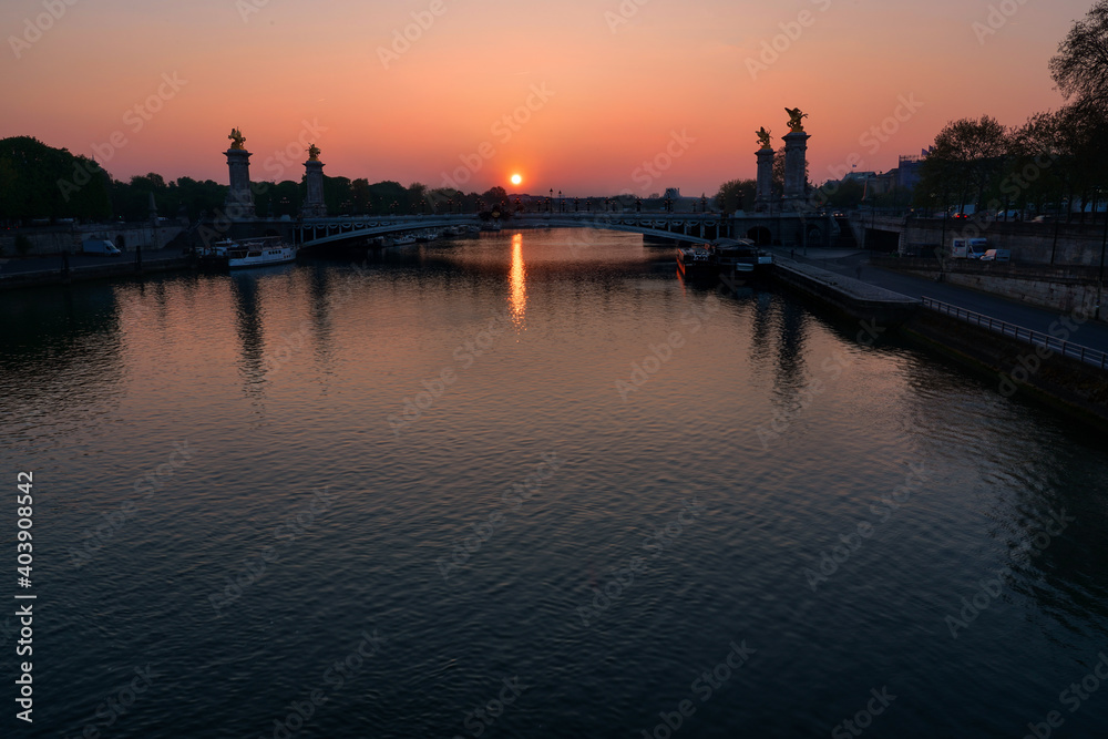 sun rising over the river seine and Pont Alexandre III bridge in Paris