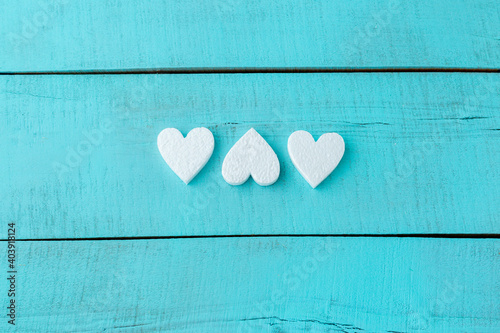 wood blue background texture with white foam hearts