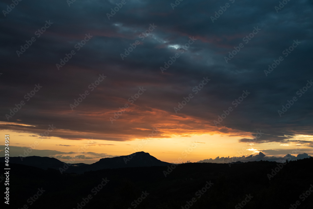 Scenic canyon view of meanders on the river Uvac, on the Zlatar Mountain with beautiful sunset with colorful and dramatic clouds and sky in background. Uvac is a special nature reserve in Serbia.