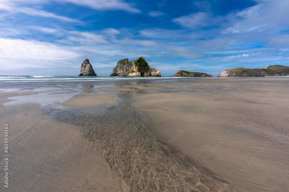 View of Wharariki Beach sea stacks in New Zealand View of Wharariki Beach sea stacks in New Zealand