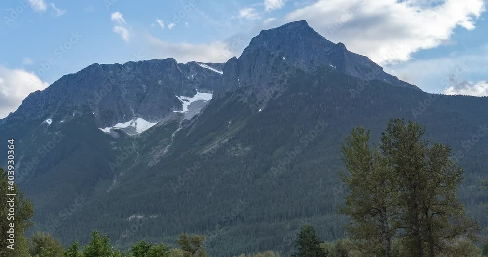 timelapse of blue sky with trees and tall mountains in the foreground timelapse of blue sky with trees and tall mountains in the foreground