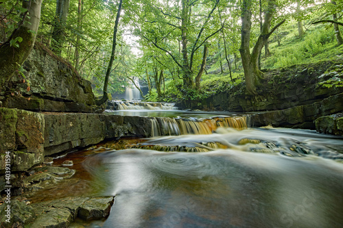 Closeup of a river with smooth effect in the Summerhill Force, UK photo