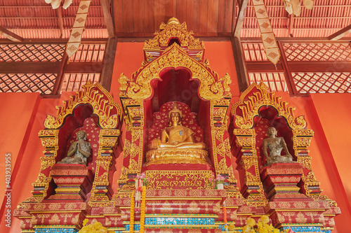 Phayao, Thailand - Dec 6, 2020: Low Angle Gold Prajao Tanjai Statue in Sanctuary or Chapel at Wat Analayo Temple with Natural Light