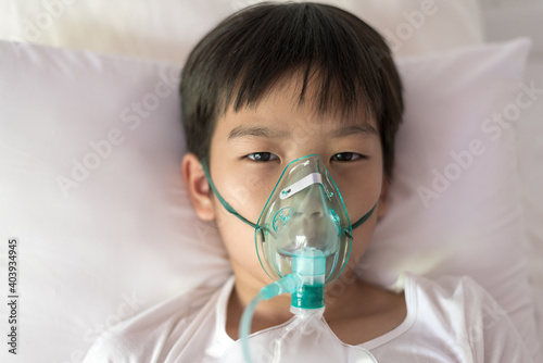 Young asian boy with face oygen mask