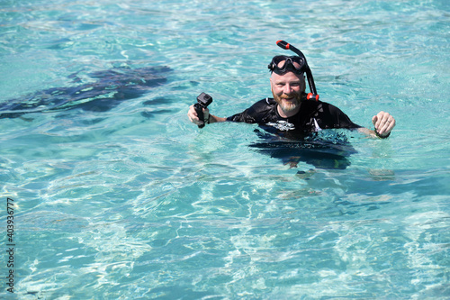 Snorkeling man in shallow ocean water