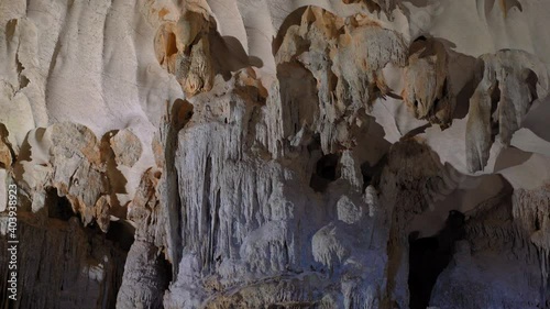 Stalactites inside of the biggest cave in the Halong Bay national park in Vietnam consisting of thousands of small and big limestone islands. Travel to Vietnam concept