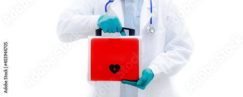 Aed rescue equipment Or a red heart defibrillator In the doctor's hand White background
