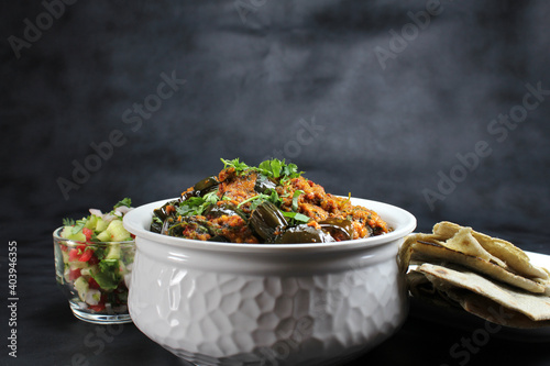 Baingan masala or Baingan curry or Eggplant Curry or Bainki sabzi is very popular Indian vegetarian dish served with roti,bhakhri or chapati. photo