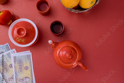 Vietnamese Money Vietnamese dong New Year decoration festival decorations of accessories in traditional container mandarin oranges on red background