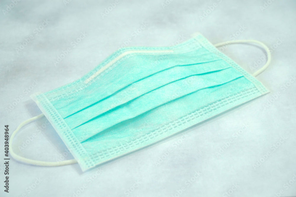 Green surgical face mask on desk. Protect pollution (PM2.5), virus, bacteria. Green surgical face mask on desk. Protect pollution (PM2.5), virus, bacteria.