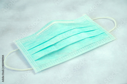 Green surgical face mask on desk. Protect pollution (PM2.5), virus, bacteria. 