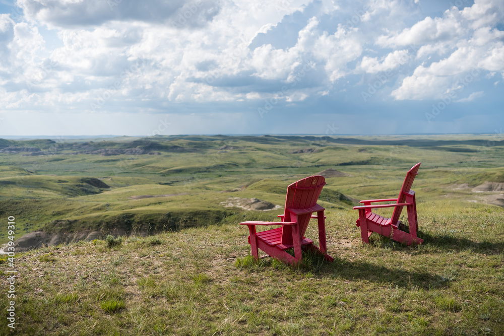 Fototapeta premium parcs canada Red chairs in grasslands national park, saskatchewan, canada