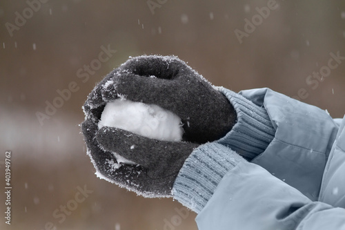 hands holding a snowball