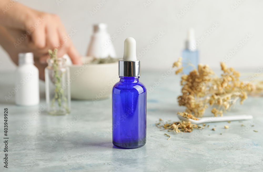 Bottle of essential oil on table Bottle of essential oil on table