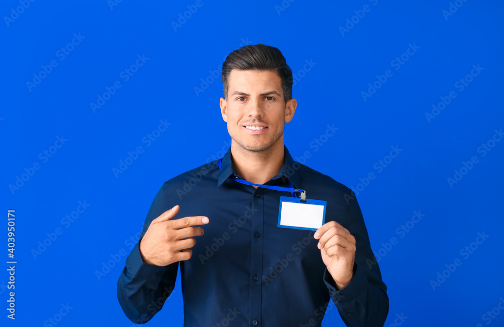 Young man with blank badge on color background Young man with blank badge on color background