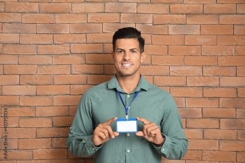 Young man with blank badge ...