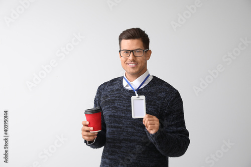 Young man with blank badge ...