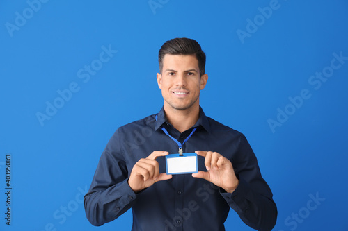 Young man with blank badge ...
