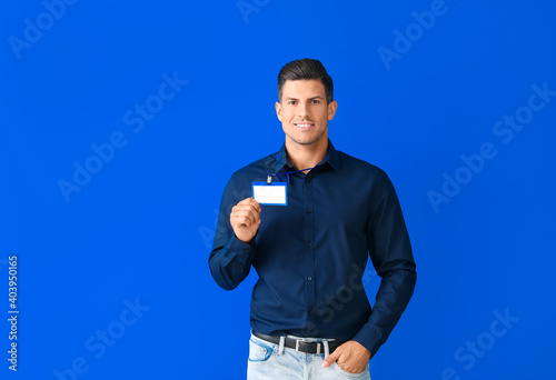 Young man with blank badge ...