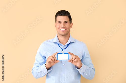 Young man with blank badge ...