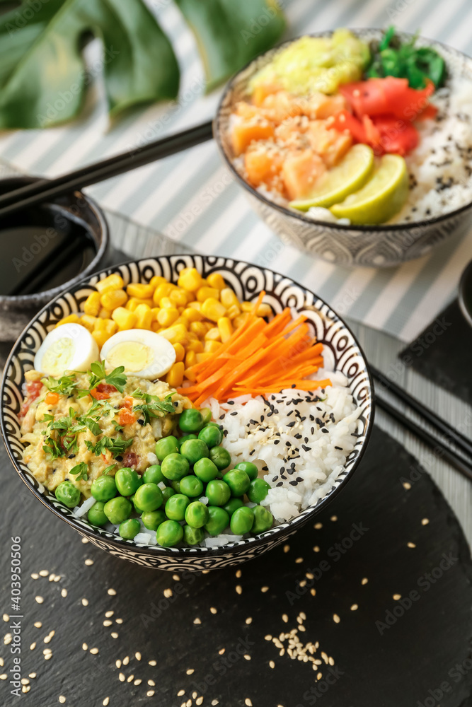 Bowls with tasty rice, eggs and vegetables on table Bowls with tasty rice, eggs and vegetables on table