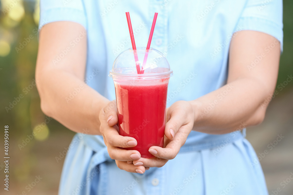 Woman with fresh watermelon juice outdoors, closeup Woman with fresh watermelon juice outdoors, closeup