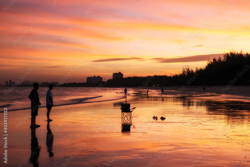 Family enjoy twilight sunset sky at beach, Cha-Am